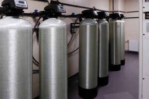 several water softener filters for water stand in a row.water treatment system.ecology.